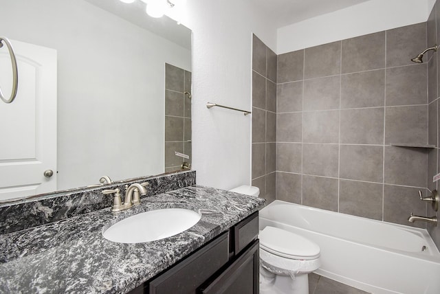 full bathroom featuring vanity, toilet, and tiled shower / bath