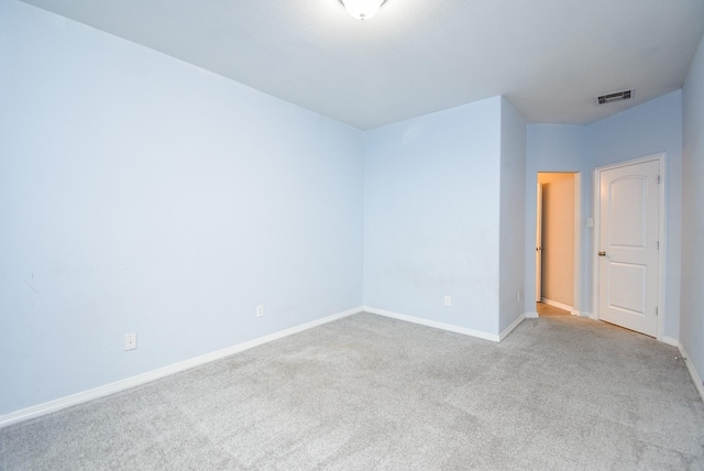 spare room featuring light carpet