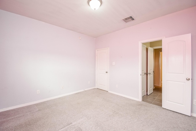 unfurnished room featuring light colored carpet