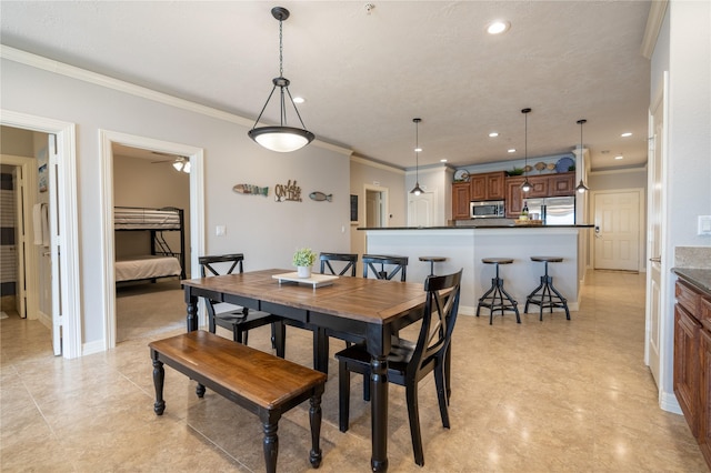 dining space featuring ceiling fan and crown molding