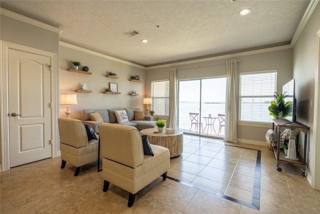 living room with light tile patterned floors, a textured ceiling, and ornamental molding