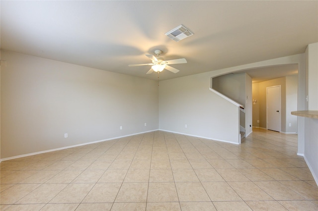 spare room featuring ceiling fan and light tile patterned floors