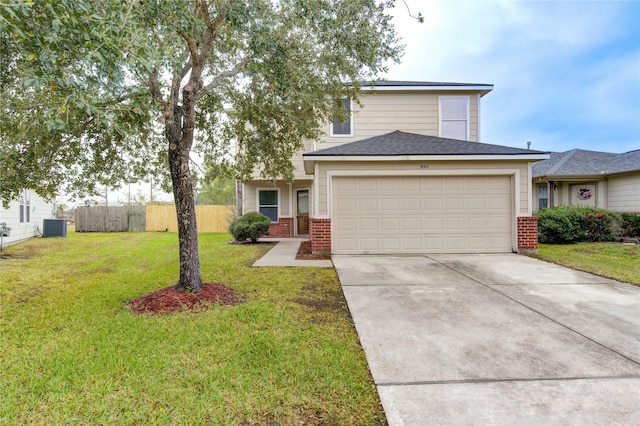 view of front of property with a garage, a front yard, and central AC