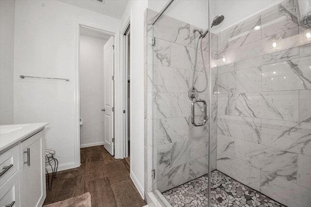 bathroom featuring vanity and a shower with door