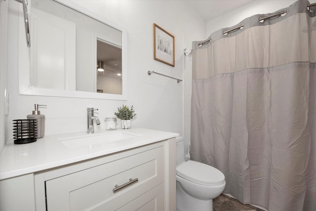 bathroom featuring vanity, toilet, and curtained shower