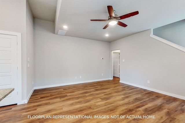 spare room featuring wood-type flooring and ceiling fan