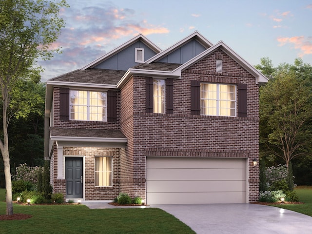 front of property featuring a lawn and a garage