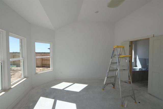 interior space with unfinished concrete flooring and vaulted ceiling