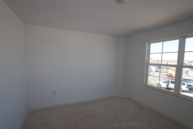 unfurnished room featuring baseboards