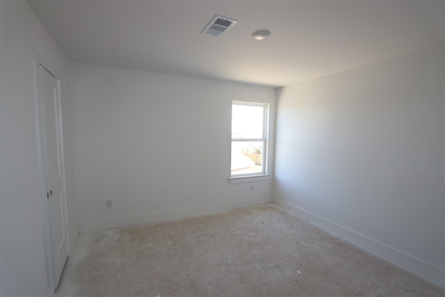 unfurnished room with visible vents and baseboards