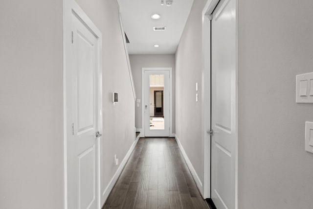 corridor with dark hardwood / wood-style floors