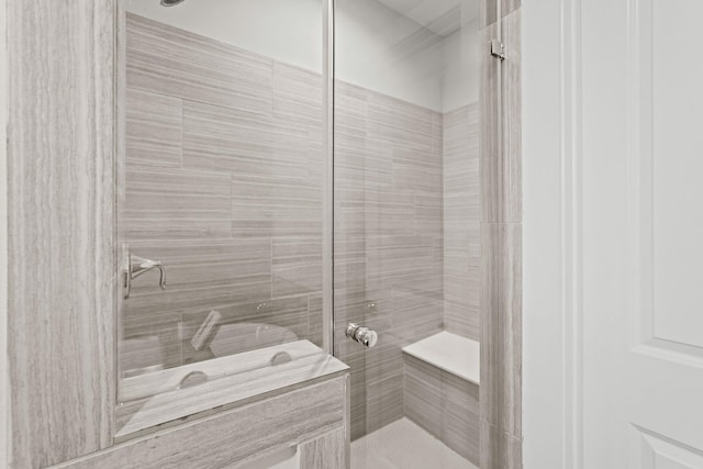 bathroom with tiled shower