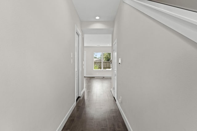 hallway with dark hardwood / wood-style floors