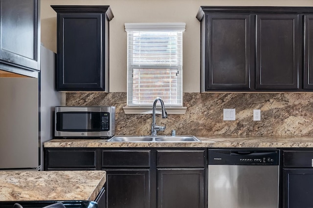 kitchen with tasteful backsplash, sink, and stainless steel appliances