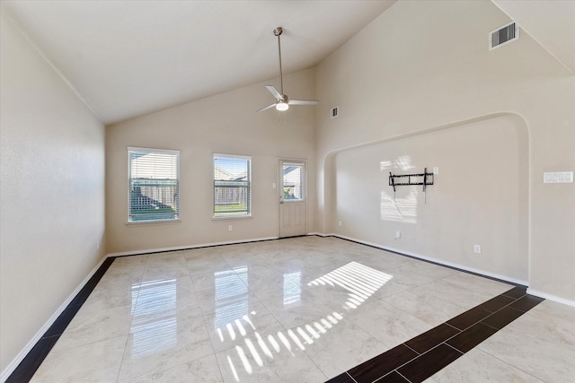 spare room with ceiling fan and high vaulted ceiling