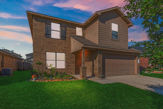 view of front facade featuring a garage, central AC unit, and a lawn