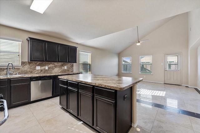 kitchen featuring ceiling fan, sink, high vaulted ceiling, dishwasher, and a center island