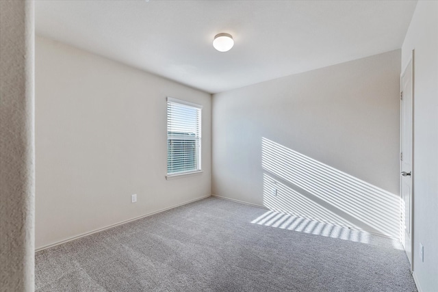 unfurnished room featuring light colored carpet