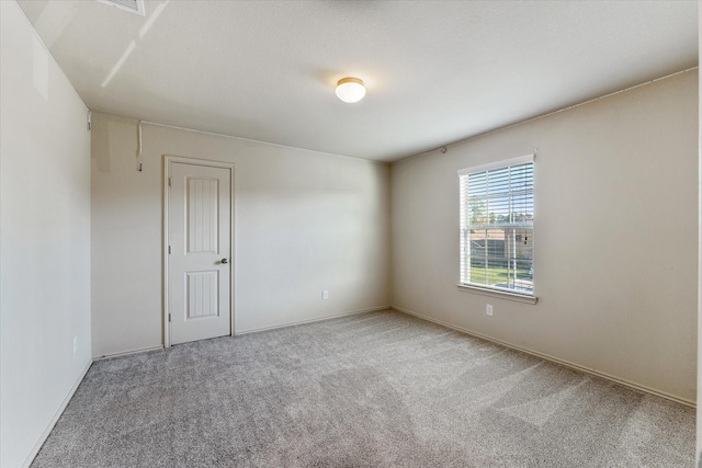 spare room featuring carpet floors