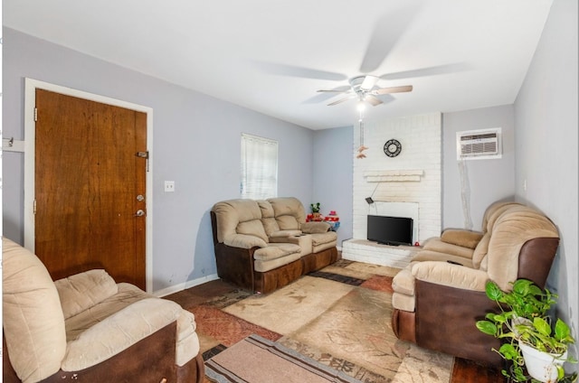 living room with a wall mounted AC, ceiling fan, and a fireplace