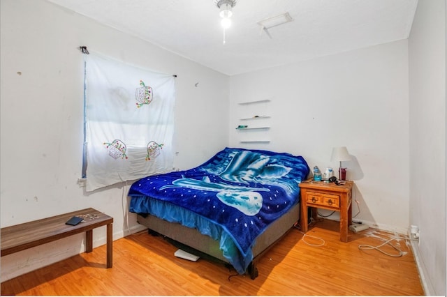 bedroom with hardwood / wood-style flooring