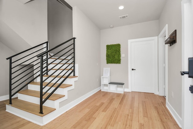 stairs with hardwood / wood-style floors