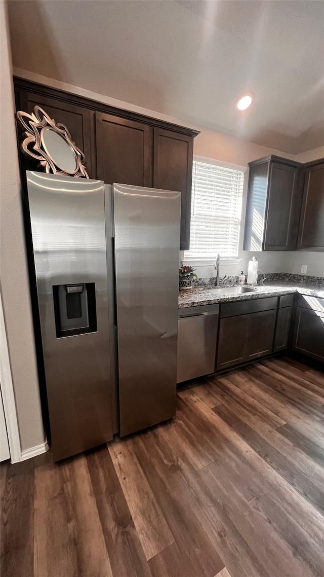 kitchen featuring appliances with stainless steel finishes, dark hardwood / wood-style flooring, and dark brown cabinets