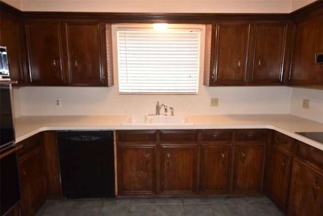 kitchen featuring sink, dark tile patterned floors, and black appliances