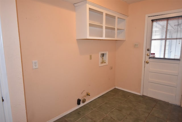 clothes washing area with dark tile patterned floors and washer hookup