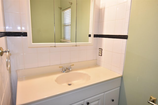 bathroom with vanity, tile walls, and tasteful backsplash