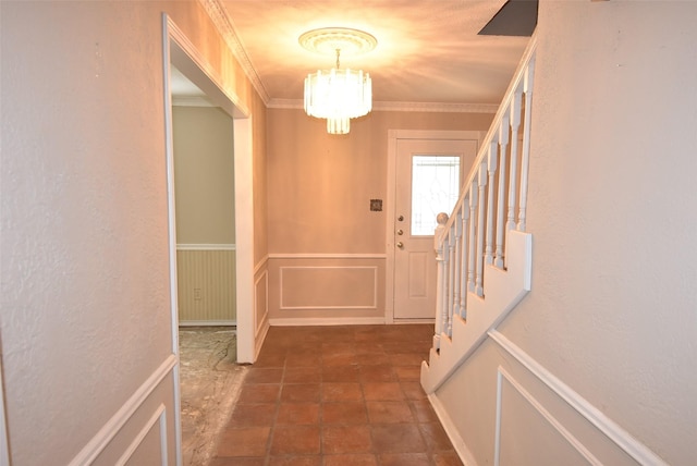 doorway to outside featuring a notable chandelier and ornamental molding