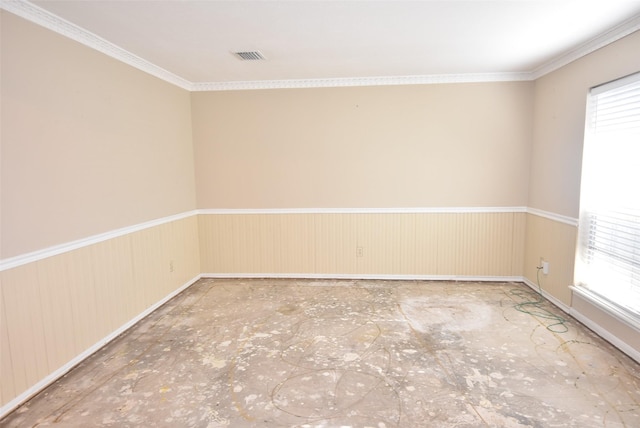 spare room featuring crown molding