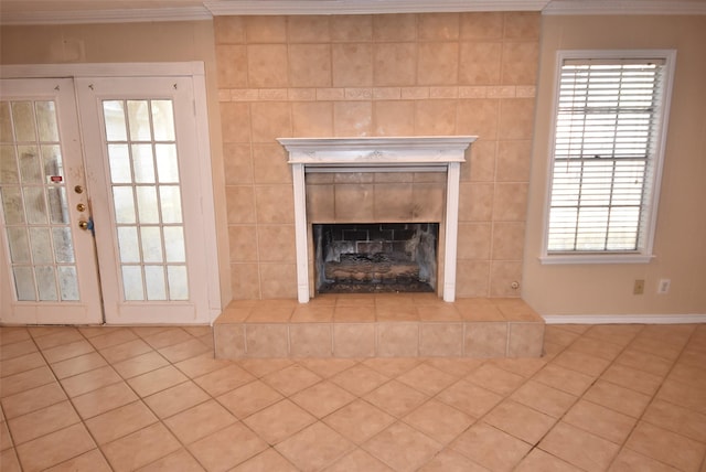 room details featuring a fireplace, crown molding, and french doors