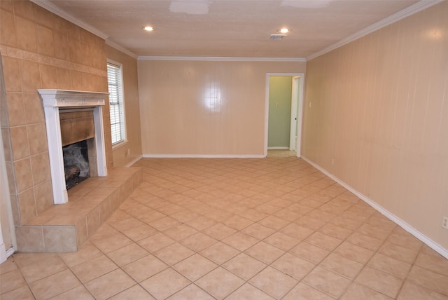 unfurnished living room featuring crown molding and a tiled fireplace