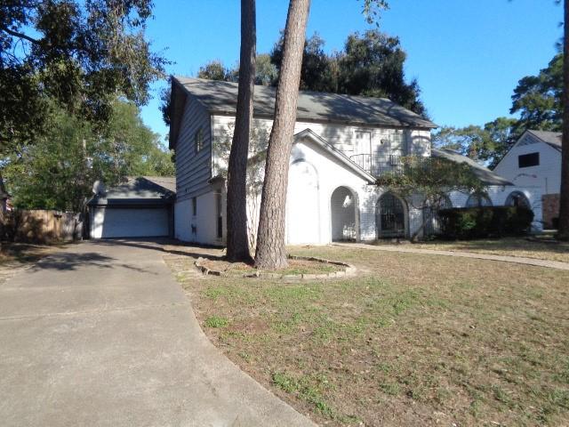 view of front of house with a garage and a front lawn