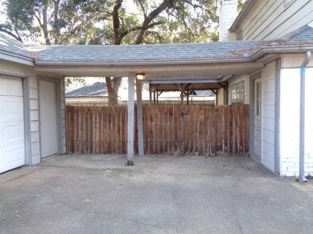 exterior space with a garage and a carport