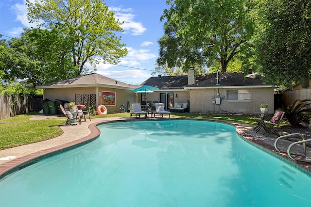 view of pool featuring a patio and a lawn