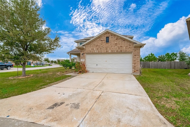 view of front of house with a front yard and a garage