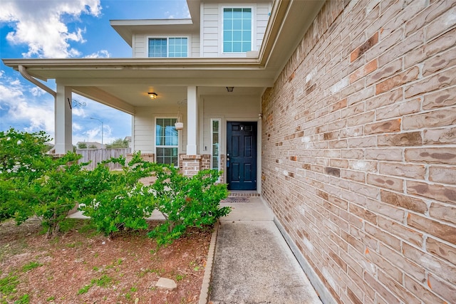 view of exterior entry with covered porch