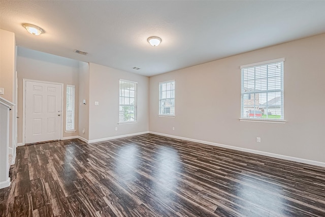 spare room with dark wood-type flooring and a textured ceiling