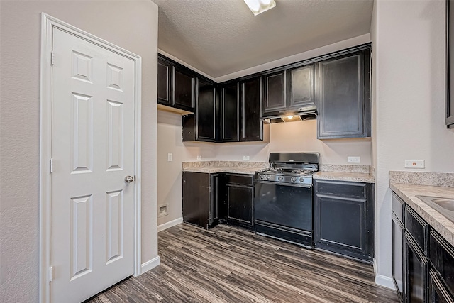 kitchen with a textured ceiling, dark hardwood / wood-style floors, and black gas range oven