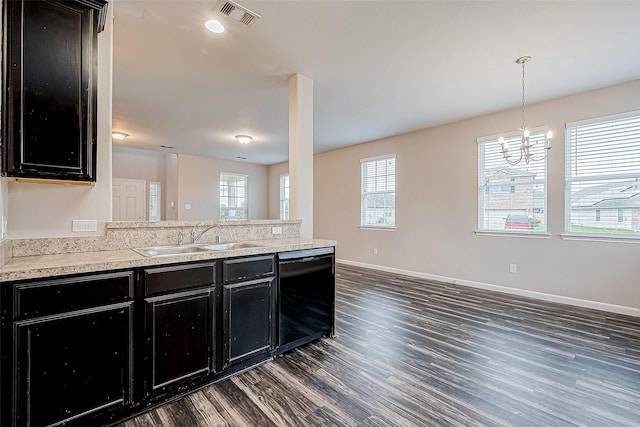 kitchen with dark wood-type flooring, sink, black dishwasher, decorative light fixtures, and a chandelier