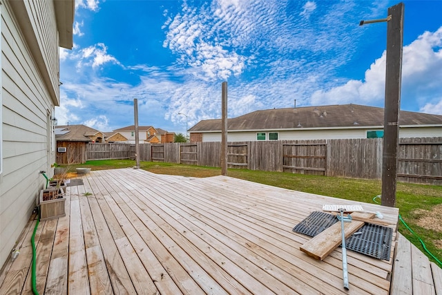 wooden terrace featuring a yard