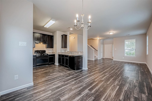 kitchen featuring a chandelier, dark wood-type flooring, black appliances, and sink