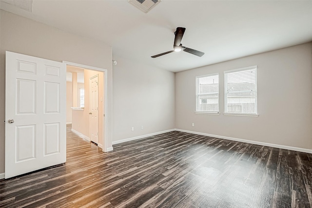 empty room featuring ceiling fan and dark wood-type flooring