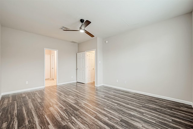 spare room with ceiling fan and dark hardwood / wood-style flooring