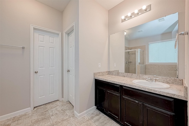 bathroom with vanity and a shower with door