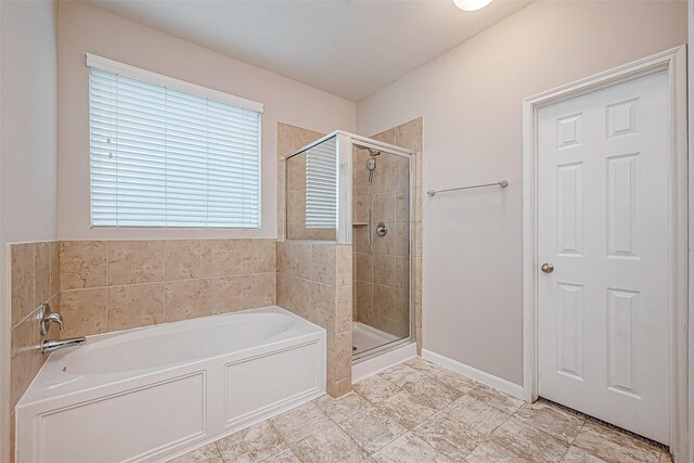 bathroom featuring shower with separate bathtub