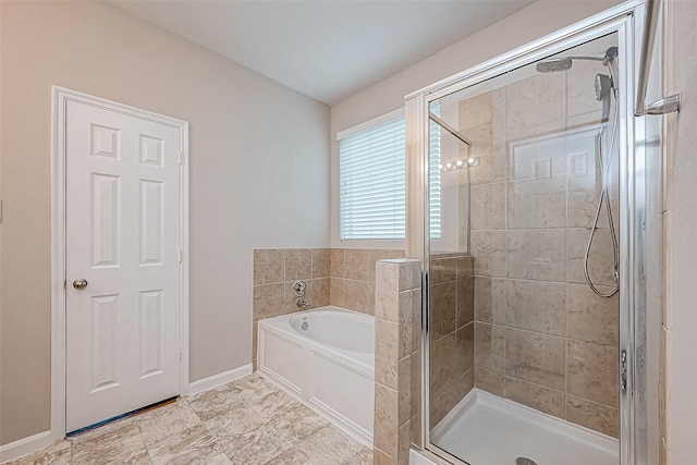 bathroom featuring shower with separate bathtub