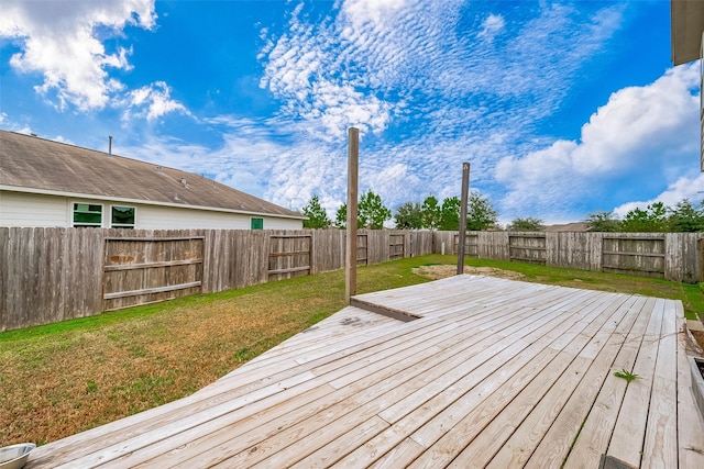 wooden terrace featuring a yard